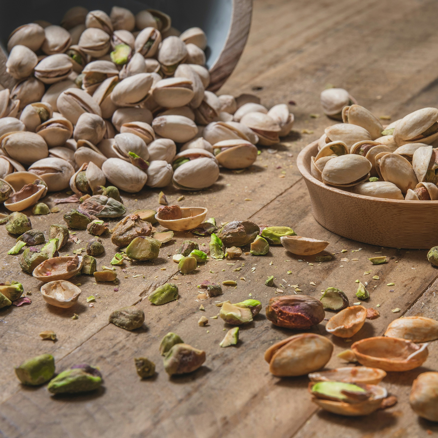 Image of pistachios scattered across a kitchen table for making Dubai Chocolate